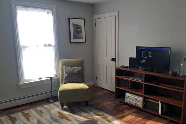 progress update of tv-room finished with new paint and flooring