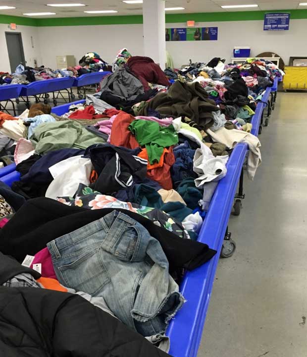 Goodwill outlet store blue bins filled with clothing