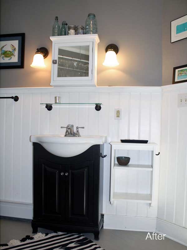 after view of renovated bathroom with new white wainscoting on walls with sink and medicine cabinet and shelf 