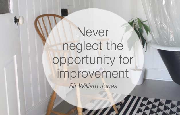 Never neglect the opportunity for improvement quote over bathroom in gray white and black 