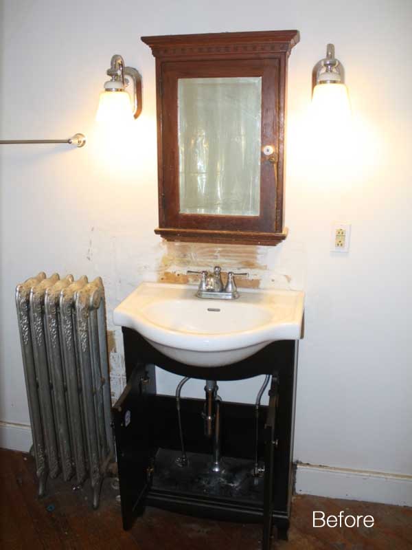 before view of old bathroom with damaged walls, sink and old radiator